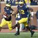 Michigan senior quarterback Denard Robinson runs the ball after a hand off from quarterback Devin Gardner during the third quarter at Michigan Stadium. Melanie Maxwell I AnnArbor.com